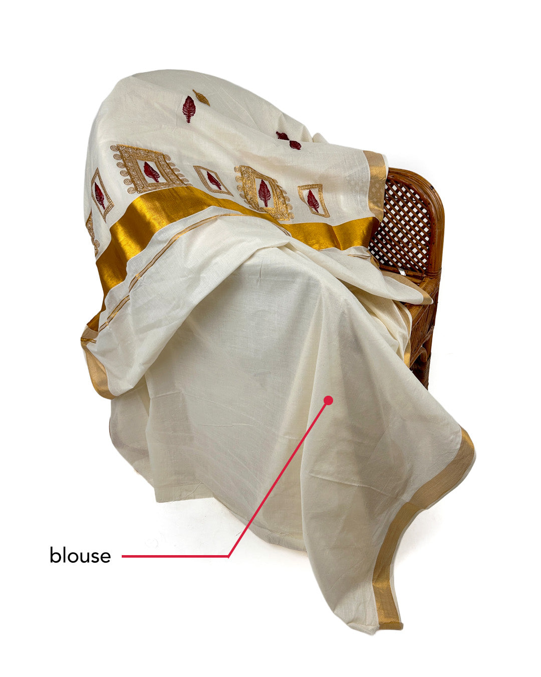 White Kerala saree with gold border draped over a chair on a white background