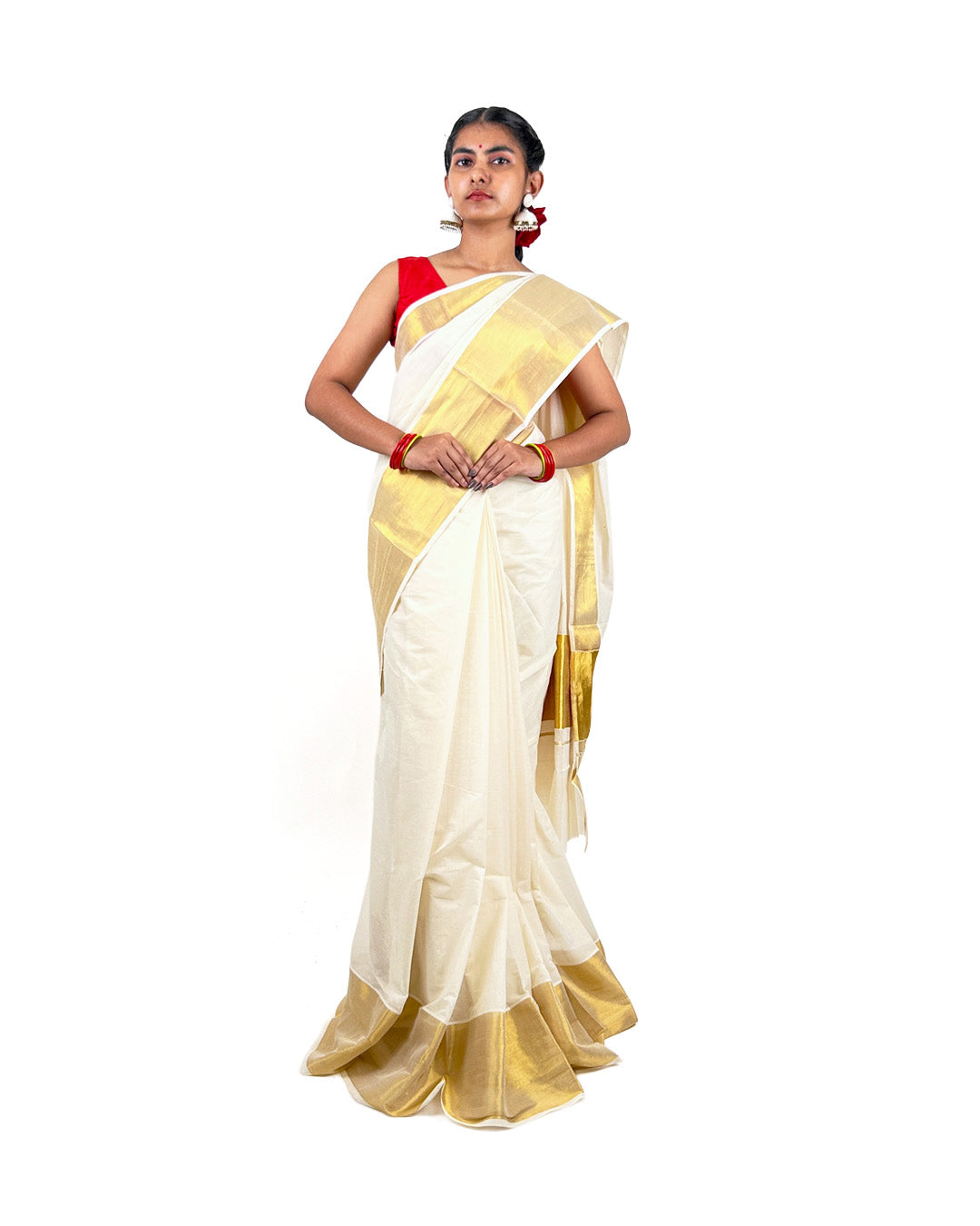 Woman wearing a white and gold kerala kasavu saree with a red blouse on a white background