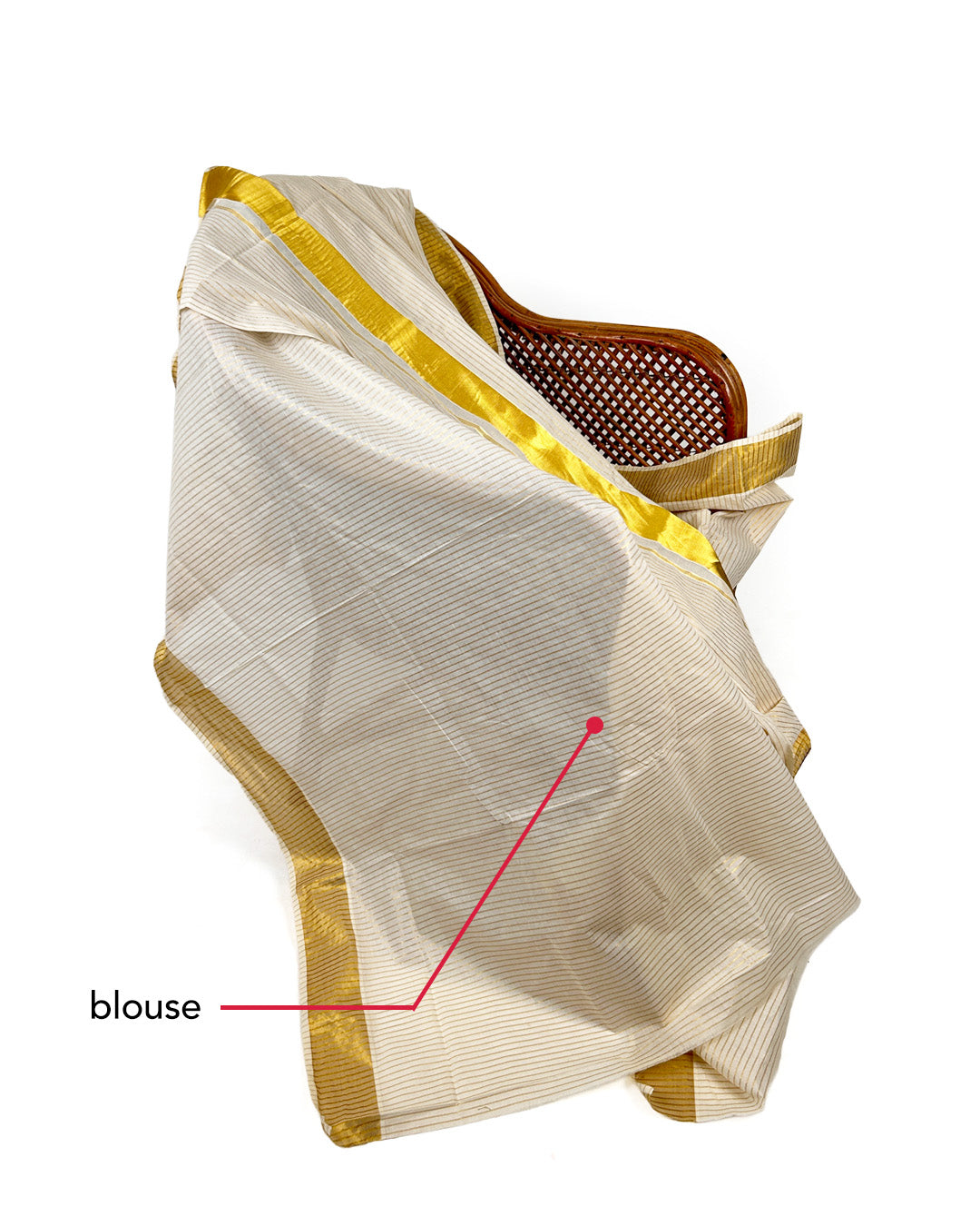 White saree with gold border draped over a chair on a white background